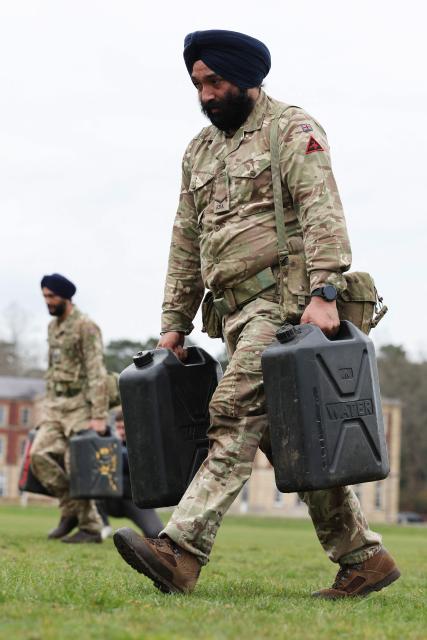Soldiers from the Defence Sikh Network and British Army take part in Holla Mohalla, the annual Sikh military festival, celebrating Sikh martial traditions at the Royal Military Academy at Sandhurst on April 01, 2026. Participants took part in a soldier Role fitness test, traditional Sikh martial arts, traditional Sikh military games, and Rang colour powder throwing. The centuries old festival is held in the spirit of fierce but well natured competition and aims to promote courage, preparation, and readiness. Sikhs have been serving in the British Army since the 1800s. (Photo by Adrian Dennis / AFP)