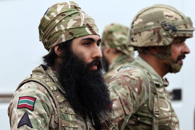 Soldiers from the Defence Sikh Network and British Army take part in Holla Mohalla, the annual Sikh military festival, celebrating Sikh martial traditions at the Royal Military Academy at Sandhurst on April 01, 2026. Participants took part in a soldier Role fitness test, traditional Sikh martial arts, traditional Sikh military games, and Rang colour powder throwing. The centuries old festival is held in the spirit of fierce but well natured competition and aims to promote courage, preparation, and readiness. Sikhs have been serving in the British Army since the 1800s. (Photo by Adrian Dennis / AFP)