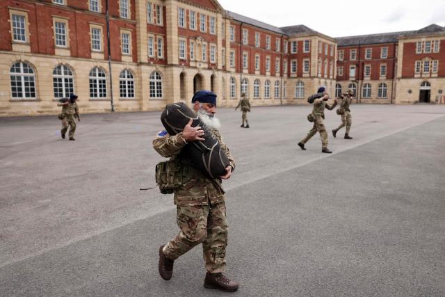 Soldiers from the Defence Sikh Network and British Army take part in Holla Mohalla, the annual Sikh military festival, celebrating Sikh martial traditions at the Royal Military Academy at Sandhurst on April 01, 2026. Participants took part in a soldier Role fitness test, traditional Sikh martial arts, traditional Sikh military games, and Rang colour powder throwing. The centuries old festival is held in the spirit of fierce but well natured competition and aims to promote courage, preparation, and readiness. Sikhs have been serving in the British Army since the 1800s. (Photo by Adrian DENNIS / AFP)
