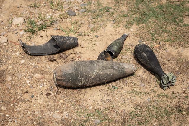 Shrapnel and remnants of munitions that damaged a house lie on the ground after being gathered by residents following explosions after a fire at a military arsenal in the Musaga district of Bujumbura, on April 1, 2026. Explosions that ripped through the city of Bujumbura after a fire in a military arsenal have killed several dozen people in the Burundian economic capital, security sources told AFP on April 1, 2026.
The explosions erupted late on March 31, 2026 at the main ammunition depot of the Burundi National Defence Force (FDNB) in Musaga, a southern suburb of Bujumbura. (Photo by Fabrice Mbonankira / AFP)