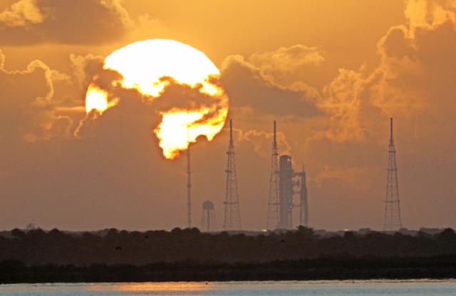 NASA's Artemis II Space Launch System (SLS) rocket is seen at sunrise at the Kennedy Space Center in Cape Canaveral, Florida on April 1, 2026. On Wednesday three men and one woman are set to embark on the first crewed journey to the Moon since 1972, a landmark odyssey that aims to launch the US into a new era of space exploration. The NASA mission dubbed Artemis 2 has been years in the making after facing repeated setbacks, but is finally scheduled to take off from Florida as early as April 1 at 6:24 pm (2224 GMT). (Photo by Gregg Newton / AFP)