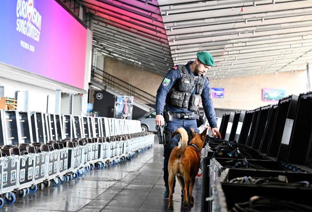 A police officer accompanied by an explosive-detection dog attends the presentation of security preparations for the Eurovision Song Contest (ESC) at the Stadthalle in Vienna on April 1, 2026. The Austrian capital Vienna will host the Eurovision Song Contest 2026 from May 12 to 16, 2026. (Photo by HANS KLAUS TECHT / APA / AFP) / Austria OUT