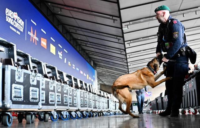 A police officer accompanied by an explosive-detection dog attends the presentation of security preparations for the Eurovision Song Contest (ESC) at the Stadthalle in Vienna on April 1, 2026. The Austrian capital Vienna will host the Eurovision Song Contest 2026 from May 12 to 16, 2026. (Photo by HANS KLAUS TECHT / APA / AFP) / Austria OUT