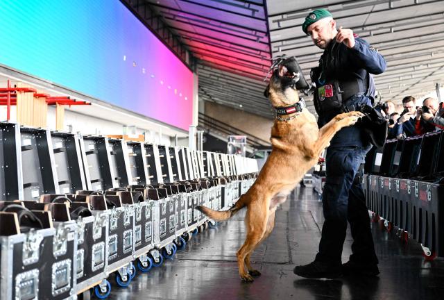 A police officer accompanied by an explosive-detection dog attends the presentation of security preparations for the Eurovision Song Contest (ESC) at the Stadthalle in Vienna on April 1, 2026. The Austrian capital Vienna will host the Eurovision Song Contest 2026 from May 12 to 16, 2026. (Photo by HANS KLAUS TECHT / APA / AFP) / Austria OUT