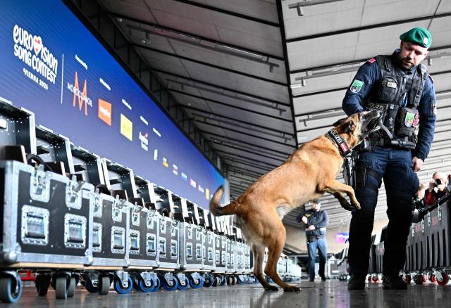 A police officer accompanied by an explosive-detection dog attends the presentation of security preparations for the Eurovision Song Contest (ESC) at the Stadthalle in Vienna on April 1, 2026. The Austrian capital Vienna will host the Eurovision Song Contest 2026 from May 12 to 16, 2026. (Photo by HANS KLAUS TECHT / APA / AFP) / Austria OUT