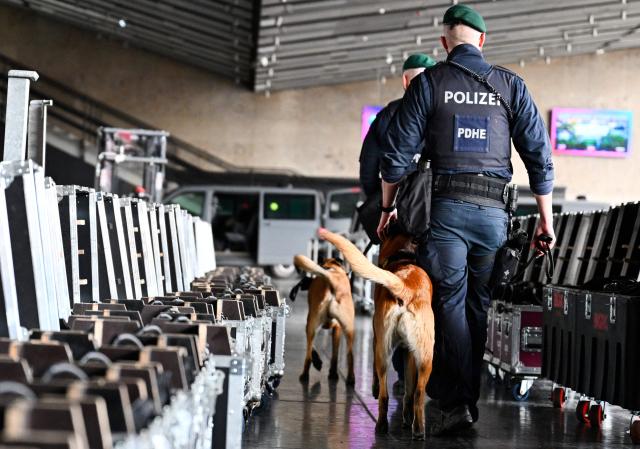 Police officers accompanied by explosive-detection dogs attend the presentation of security preparations for the Eurovision Song Contest (ESC) at the Stadthalle in Vienna on April 1, 2026. The Austrian capital Vienna will host the Eurovision Song Contest 2026 from May 12 to 16, 2026. (Photo by HANS KLAUS TECHT / APA / AFP) / Austria OUT
