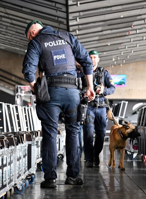 Police officers accompanied by an explosive-detection dog attend the presentation of security preparations for the Eurovision Song Contest (ESC) at the Stadthalle in Vienna on April 1, 2026. The Austrian capital Vienna will host the Eurovision Song Contest 2026 from May 12 to 16, 2026. (Photo by HANS KLAUS TECHT / APA / AFP) / Austria OUT