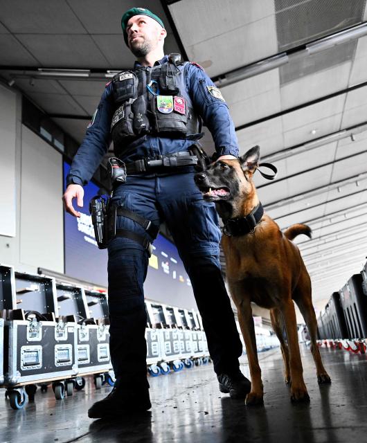 A police officer accompanied by an explosive-detection dog attends the presentation of security preparations for the Eurovision Song Contest (ESC) at the Stadthalle in Vienna on April 1, 2026. The Austrian capital Vienna will host the Eurovision Song Contest 2026 from May 12 to 16, 2026. (Photo by HANS KLAUS TECHT / APA / AFP) / Austria OUT