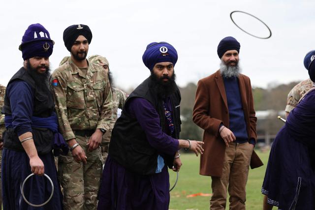 Soldiers from the Defence Sikh Network and British Army take part in a game of qouits during Holla Mohalla, the annual Sikh military festival, celebrating Sikh martial traditions at the Royal Military Academy at Sandhurst on April 01, 2026. Participants took part in a soldier Role fitness test, traditional Sikh martial arts, traditional Sikh military games, and Rang colour powder throwing. The centuries old festival is held in the spirit of fierce but well natured competition and aims to promote courage, preparation, and readiness. Sikhs have been serving in the British Army since the 1800s. (Photo by Adrian Dennis / AFP)
