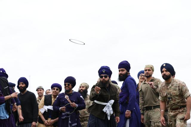 Soldiers from the Defence Sikh Network and British Army take part in a game of qouits during Holla Mohalla, the annual Sikh military festival, celebrating Sikh martial traditions at the Royal Military Academy at Sandhurst on April 01, 2026. Participants took part in a soldier Role fitness test, traditional Sikh martial arts, traditional Sikh military games, and Rang colour powder throwing. The centuries old festival is held in the spirit of fierce but well natured competition and aims to promote courage, preparation, and readiness. Sikhs have been serving in the British Army since the 1800s. (Photo by Adrian Dennis / AFP)