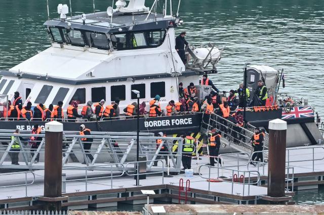 Migrants disembark a British Border Force vessel after being picked up at sea, while attempting to cross the English Channel from France, at the Port of Dover in southeast England, on April 1, 2026.  (Photo by JUSTIN TALLIS / AFP)