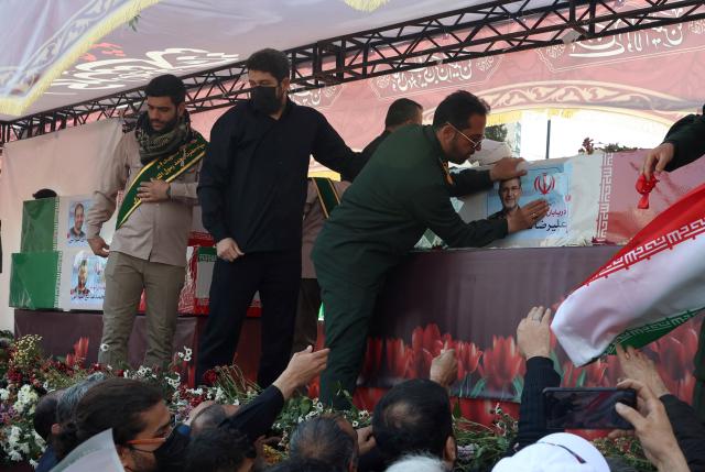A military personnel touches the coffin of Alireza Tangsiri, commander of the Iranian Revolutionary Guards' navy during his funeral alongside others killed in US-Israeli strikes on Iran at Enghelab Square in Tehran on April 1, 2026. Iran confirmed on March 30 that an Israeli strike had killed the commander of the naval force of the Revolutionary Guards, who Israel had said was responsible for the blocking of the Strait of Hormuz. A statement carried by the Guards' Sepah News website said Alireza Tangsiri "succumbed to severe injuries" from the attack last week. (Photo by AFP) / 