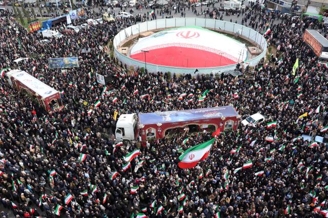 Iranians attend the funeral of Alireza Tangsiri, commander of the Iranian Revolutionary Guards' navy alongside others killed in US-Israeli strikes on Iran at Enghelab Square in Tehran on April 1, 2026. Iran confirmed on March 30 that an Israeli strike had killed the commander of the naval force of the Revolutionary Guards, who Israel had said was responsible for the blocking of the Strait of Hormuz. A statement carried by the Guards' Sepah News website said Alireza Tangsiri "succumbed to severe injuries" from the attack last week. (Photo by AFP) / 