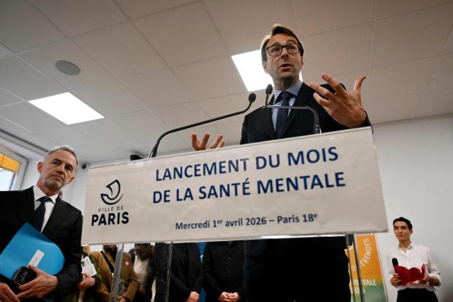 Laurent Noe (C), director of the Paris Academy, delivers a speech next to Paris Mayor Paris' Emmanuel Gregoire (L) during a mental health conference (Assises de la sante mentale) in Paris on April 1, 2026. (Photo by Anna KURTH / AFP)