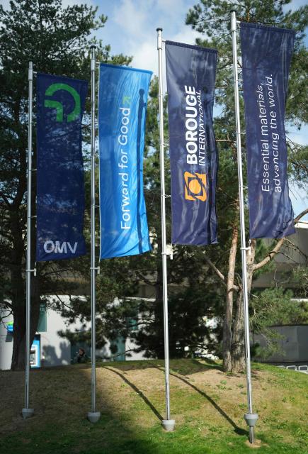 Company flags of Austrian energy group OMV, the Emirati firm ADNOC (Abu Dhabi National Oil Company) and Borouge International flutter in front of OMV’s headquarters in Vienna, on April 1, 2026. Austria’s hydrocarbons company OMV and the Emirati firm ADNOC (Abu Dhabi National Oil Company) jointly created a new global leader in plastics production, Borouge International, on March 31, 2026, confirming their diversification strategy in the fast-growing chemicals sector. (Photo by GEORG HOCHMUTH / APA / AFP) / Austria OUT