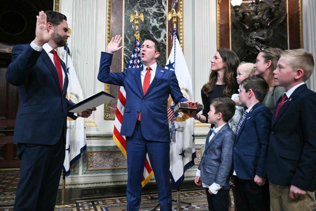(L/R) US Vice President JD Vance swears in Colin McDonald as Assistant Attorney General for the National Fraud Enforcement Division as McDonald's wife Janessa holds the Bible in the Eisenhower Executive Office Building, next to the White House in Washington, DC on April 1, 2026. McDonald will be the first Assistant Attorney General for the Department of Justice's newly created National Fraud Enforcement Division. (Photo by Mandel NGAN / AFP)