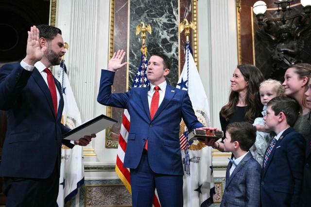 (L/R) US Vice President JD Vance swears in Colin McDonald as Assistant Attorney General for the National Fraud Enforcement Division as McDonald's wife Janessa holds the Bible in the Eisenhower Executive Office Building, next to the White House in Washington, DC on April 1, 2026. McDonald will be the first Assistant Attorney General for the Department of Justice's newly created National Fraud Enforcement Division. (Photo by Mandel NGAN / AFP)