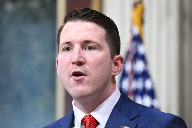 Colin McDonald, the Assistant Attorney General for the National Fraud Enforcement Division, speaks after being sworn in by US Vice President JD Vance in the Eisenhower Executive Office Building, next to the White House in Washington, DC on April 1, 2026. McDonald will be the first Assistant Attorney General for the Department of Justice's newly created National Fraud Enforcement Division. (Photo by Mandel NGAN / AFP)