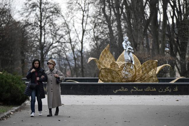People walk through the Gryshko National Botanical Garden in Kyiv on April 1, 2026, amid the Russian invasion of Ukraine. (Photo by Genya SAVILOV / AFP)
