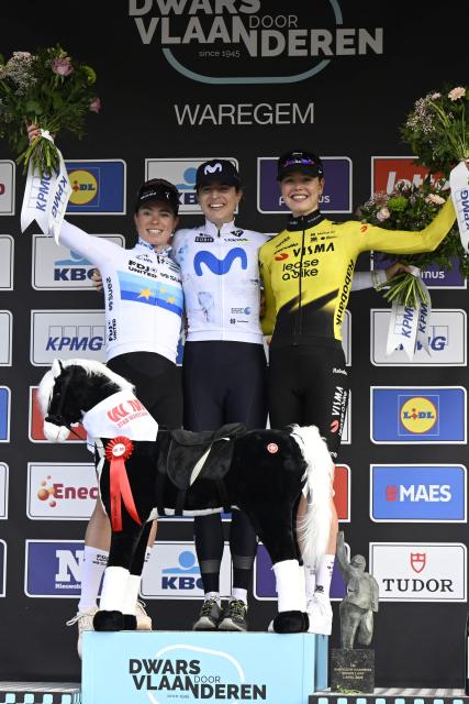 (From L) Second-placed FDJ United-SUEZ' Dutch rider Demi Vollering, winner Movistar Team's Swiss rider Marlen Reusser and third-placed Team Visma-Lease a Bike Dutch rider Lieke Nooijen celebrate on the podium after the women elite race of the 'Dwars Door Vlaanderen' cycling event, 128.9 km from Roeselare to Waregem on April 1, 2026. (Photo by Tom Goyvaerts / Belga / AFP) / Belgium OUT
