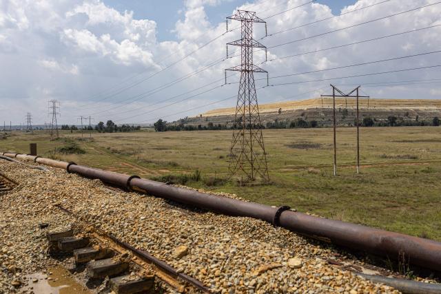 A general view of a derelict railway viaduct, severed at both ends stands adjacent to a mine tailing near Randfontein on April 1, 2026. (Photo by EMMANUEL CROSET / AFP)