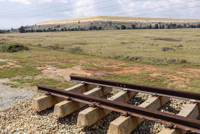 A general view of a derelict railway viaduct, severed at both ends stands adjacent to a mine tailing near Randfontein on April 1, 2026. (Photo by EMMANUEL CROSET / AFP)
