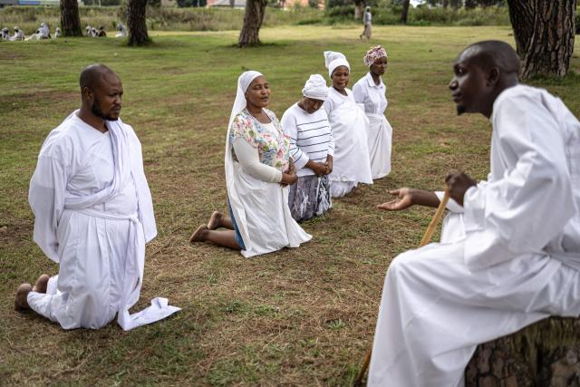 A religious leader addresses congregants during an open-air service held by the Johani Masowe of Baba Emmanuel church near Randfontein on April 1, 2026. (Photo by EMMANUEL CROSET / AFP)