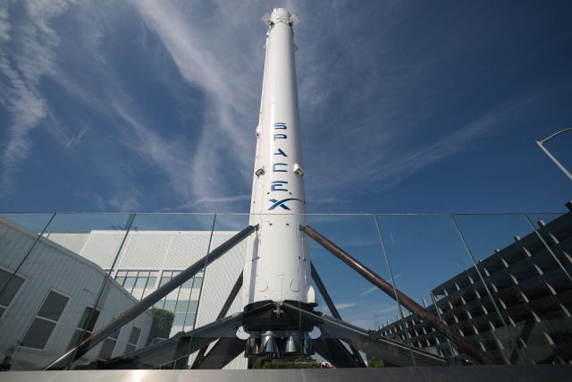 (FILES) A SpaceX Falcon 9 rocket is displayed outside a Space Exploration Technologies Corp. facility in Hawthorne, California on March 26, 2026. Elon Musk's SpaceX has filed confidential papers with US securities regulators to go public, US media reported on April 1, 2026. The filing, which could be the largest initial public offering of all time, puts SpaceX on track to list on a public exchange by July, according to the Wall Street Journal and Bloomberg, which cited people familiar with the matter. (Photo by Patrick T. Fallon / AFP)