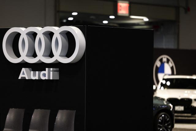 The logos of car manufacturers Audi and BMW are pictured during the press preview for the New York International Auto Show at the Jacob Javits Convention Center in New York City on April 1, 2026. (Photo by CHARLY TRIBALLEAU / AFP)
