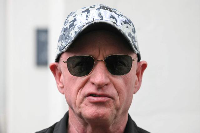 US Senator Mark Kelly, Democrat from Arizona, speaks ahead of the crew walk out for the Artemis II crewed lunar mission at Kennedy Space Center in Cape Canaveral, Florida, on April 1, 2026. On Wednesday three men and one woman are set to embark on the first crewed journey to the Moon since 1972, a landmark odyssey that aims to launch the US into a new era of space exploration. The NASA mission dubbed Artemis 2 has been years in the making after facing repeated setbacks, but is finally scheduled to take off from Florida as early as April 1 at 6:24 pm (2224 GMT). (Photo by Jim WATSON / AFP)