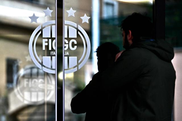 A man enters the headquarters of the Italian Football Federation (FIGC) in Rome on April 1, 2026. Italy's Sport Minister Andrea Abodi said on April 1, 2026 the head of the country's football federation should step down after the national team failed to qualify for a third consecutive World Cup. The Azzurri fell at the play-offs again, this time after a penalty shoot-out against Bosnia and Hercegovina on March 31, and will miss this summer's finals in the United States, Canada and Mexico. (Photo by Filippo MONTEFORTE / AFP)