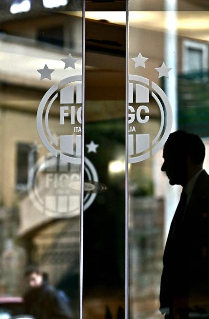 A man enters the headquarters of the Italian Football Federation (FIGC) in Rome on April 1, 2026. Italy's Sport Minister Andrea Abodi said on April 1, 2026 the head of the country's football federation should step down after the national team failed to qualify for a third consecutive World Cup. The Azzurri fell at the play-offs again, this time after a penalty shoot-out against Bosnia and Hercegovina on March 31, and will miss this summer's finals in the United States, Canada and Mexico. (Photo by Filippo MONTEFORTE / AFP)