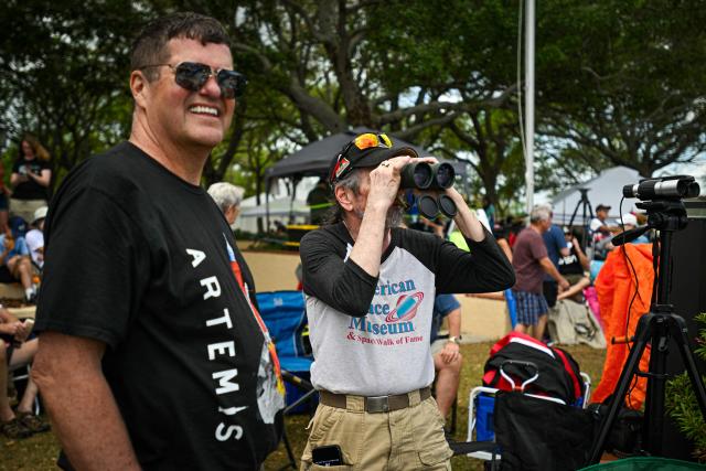 Space enthusiasts gather at a park in Titusville, Florida several hours before NASA's Artemis II Space Launch System (SLS) rocket is scheduled to launch from the Kennedy Space Center on April 1, 2026. On Wednesday three men and one woman are set to embark on the first crewed journey to the Moon since 1972, a landmark odyssey that aims to launch the US into a new era of space exploration. The NASA mission dubbed Artemis 2 has been years in the making after facing repeated setbacks, but is finally scheduled to take off from Florida as early as April 1 at 6:24 pm (2224 GMT). (Photo by Miguel J Rodriguez Carrillo / AFP)