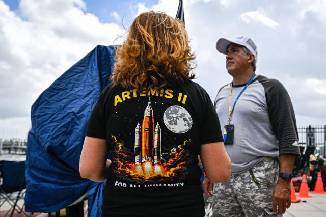 Space enthusiasts gather at a park in Titusville, Florida several hours before NASA's Artemis II Space Launch System (SLS) rocket is scheduled to launch from the Kennedy Space Center on April 1, 2026. On Wednesday three men and one woman are set to embark on the first crewed journey to the Moon since 1972, a landmark odyssey that aims to launch the US into a new era of space exploration. The NASA mission dubbed Artemis 2 has been years in the making after facing repeated setbacks, but is finally scheduled to take off from Florida as early as April 1 at 6:24 pm (2224 GMT). (Photo by Miguel J Rodriguez Carrillo / AFP)