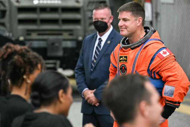 Canadian Space Agency (CSA) astronaut Jeremy Hansen, Artemis II mission specialist, walks out to board a bus before traveling to the launch pad to board the Space Launch System (SLS) rocket for the Artemis II crewed lunar mission at Kennedy Space Center in Cape Canaveral, Florida, on April 1, 2026. On Wednesday three men and one woman are set to embark on the first crewed journey to the Moon since 1972, a landmark odyssey that aims to launch the US into a new era of space exploration. The NASA mission dubbed Artemis 2 has been years in the making after facing repeated setbacks, but is finally scheduled to take off from Florida as early as April 1 at 6:24 pm (2224 GMT). (Photo by Jim WATSON / AFP)