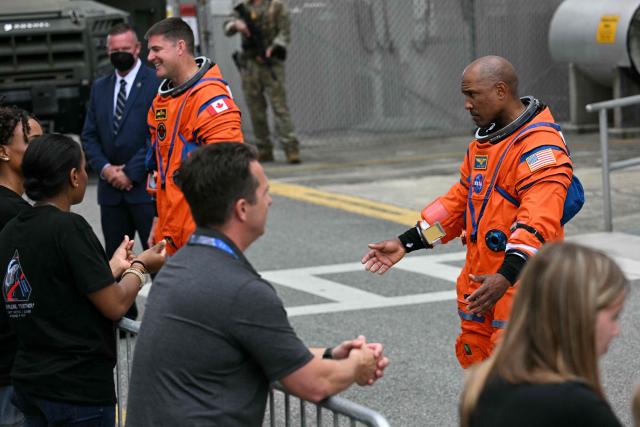 NASA astronaut Victor Glover, Artemis II pilot, gestures to friends and family as the Artemis II mission crew says farewell before traveling to the launch pad to board the Space Launch System (SLS) rocket for the Artemis II crewed lunar mission at Kennedy Space Center in Cape Canaveral, Florida, on April 1, 2026. On Wednesday three men and one woman are set to embark on the first crewed journey to the Moon since 1972, a landmark odyssey that aims to launch the US into a new era of space exploration. The NASA mission dubbed Artemis 2 has been years in the making after facing repeated setbacks, but is finally scheduled to take off from Florida as early as April 1 at 6:24 pm (2224 GMT). (Photo by Jim WATSON / AFP)