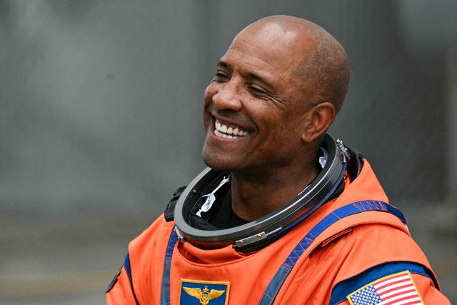 NASA astronaut Victor Glover, Artemis II pilot, smiles as he walks out before boarding a bus to travel to the launch pad to board the Space Launch System (SLS) rocket for the Artemis II crewed lunar mission at Kennedy Space Center in Cape Canaveral, Florida, on April 1, 2026. On Wednesday three men and one woman are set to embark on the first crewed journey to the Moon since 1972, a landmark odyssey that aims to launch the US into a new era of space exploration. The NASA mission dubbed Artemis 2 has been years in the making after facing repeated setbacks, but is finally scheduled to take off from Florida as early as April 1 at 6:24 pm (2224 GMT). (Photo by Jim WATSON / AFP)
