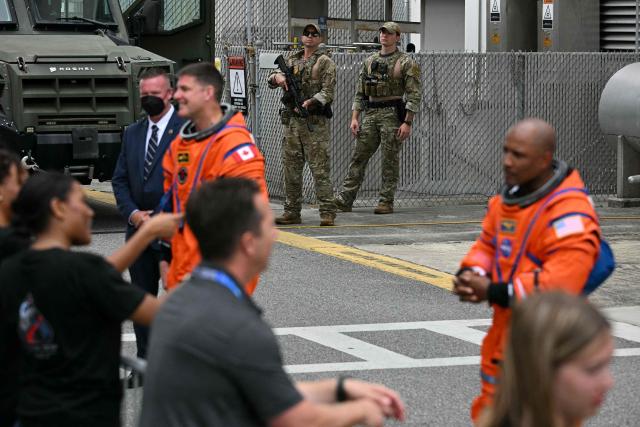 Members of the NASA SWAT team look on as the Artemis II mission crew says farewell to friends and family before traveling to the launch pad to board the Space Launch System (SLS) rocket for the Artemis II crewed lunar mission at Kennedy Space Center in Cape Canaveral, Florida, on April 1, 2026. On Wednesday three men and one woman are set to embark on the first crewed journey to the Moon since 1972, a landmark odyssey that aims to launch the US into a new era of space exploration. The NASA mission dubbed Artemis 2 has been years in the making after facing repeated setbacks, but is finally scheduled to take off from Florida as early as April 1 at 6:24 pm (2224 GMT). (Photo by Jim WATSON / AFP)