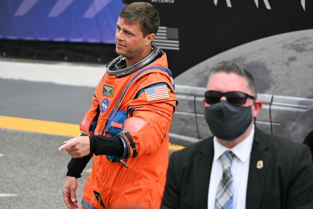 NASA astronaut Reid Wiseman (L), Artemis II commander, walks out to board a bus to travel to the launch pad to board the Space Launch System (SLS) rocket for the Artemis II crewed lunar mission at Kennedy Space Center in Cape Canaveral, Florida, on April 1, 2026. On Wednesday three men and one woman are set to embark on the first crewed journey to the Moon since 1972, a landmark odyssey that aims to launch the US into a new era of space exploration. The NASA mission dubbed Artemis 2 has been years in the making after facing repeated setbacks, but is finally scheduled to take off from Florida as early as April 1 at 6:24 pm (2224 GMT). (Photo by Jim WATSON / AFP)