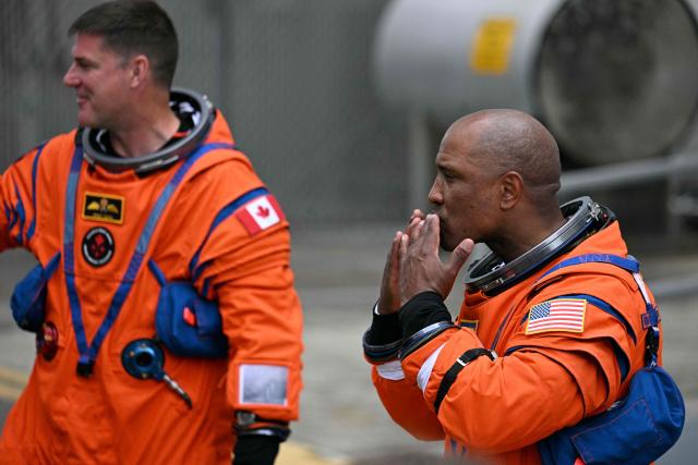 NASA astronaut Victor Glover, Artemis II pilot, blows a kiss to friends and family as the Artemis II mission crew says farewell before traveling to the launch pad to board the Space Launch System (SLS) rocket for the Artemis II crewed lunar mission at Kennedy Space Center in Cape Canaveral, Florida, on April 1, 2026. On Wednesday three men and one woman are set to embark on the first crewed journey to the Moon since 1972, a landmark odyssey that aims to launch the US into a new era of space exploration. The NASA mission dubbed Artemis 2 has been years in the making after facing repeated setbacks, but is finally scheduled to take off from Florida as early as April 1 at 6:24 pm (2224 GMT). (Photo by Jim WATSON / AFP)
