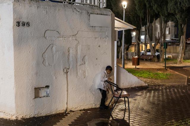 A young ulta-Orthodox Jewish boy plays outside a shelter on Passover evening in Nahariya on April 1, 2026. According to biblical narrative, due to the haste with which the Jews left Egypt, the bread they had prepared for the journey did not have time to rise. To commemorate their ancestors' plight, the religious avoid eating leavened food products throughout Passover. (Photo by Ilia YEFIMOVICH / AFP)