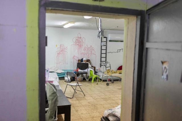 A religious woman reads inside a shelter ahead of Passover celebration in Akko (Acre), northern Israel on April 1, 2026. According to biblical narrative, due to the haste with which the Jews left Egypt, the bread they had prepared for the journey did not have time to rise. To commemorate their ancestors' plight, the religious avoid eating leavened food products throughout Passover. (Photo by Ilia YEFIMOVICH / AFP)
