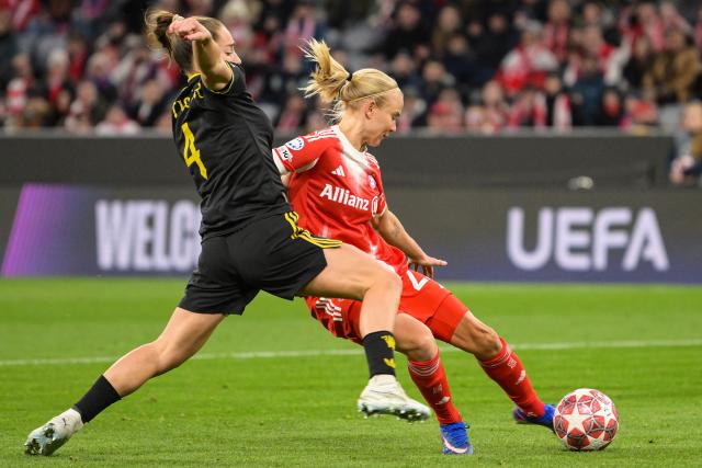 Manchester United's English defender #04 Maya Le Tissier (L) and Bayern Munich's Danish forward #21 Pernille Harder vie for the ball during the UEFA Women's Champions League, Quarter Final second-leg football match between FC Bayern Munich and Manchester United in Munich on April, 1 2026. (Photo by Markus FISCHER / AFP)