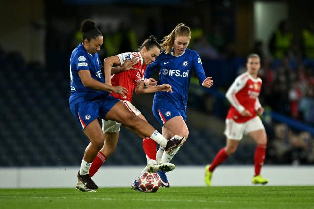 Arsenal's Australian striker #19 Caitlin Foord is put under pressure by Chelsea's English striker #10 Lauren James (L) and Chelsea's German midfielder #06 Sjoeke Nusken during the UEFA Women's Champions League Quarter Final second-leg football match between Chelsea and Arsenal at Stamford Bridge in London on April 1, 2026. (Photo by Ben STANSALL / AFP)