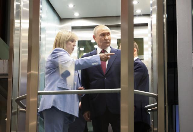 This pool photograph distributed by the Russian state agency Sputnik, shows Russia's President Vladimir Putin (R) talking to the chairperson of the Central Election Comission Ella Pamfilova (L) during his meeting with the new members of the Central Election Comission in Moscow on April 1, 2026. (Photo by Viacheslav PROKOFIEV / POOL / AFP)