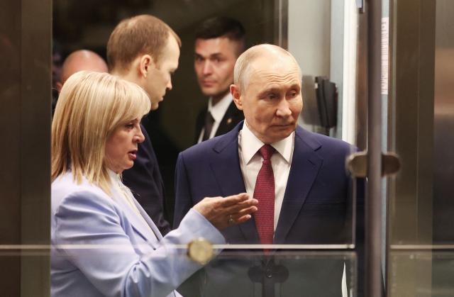 This pool photograph distributed by the Russian state agency Sputnik, shows Russia's President Vladimir Putin (R) talking to the chairperson of the Central Election Comission Ella Pamfilova (L) during his meeting with the new members of the Central Election Comission in Moscow on April 1, 2026. (Photo by Viacheslav PROKOFIEV / POOL / AFP)