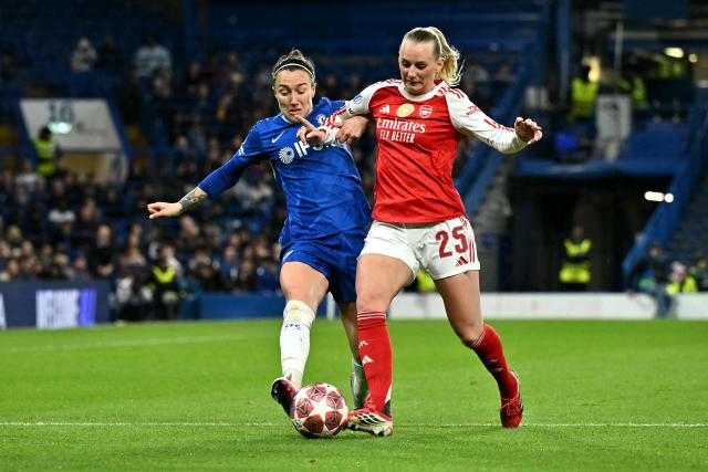Chelsea's English defender #22 Lucy Bronze battles for the ball with Arsenal's Swedish striker #25 Stina Blackstenius during the UEFA Women's Champions League Quarter Final second-leg football match between Chelsea and Arsenal at Stamford Bridge in London on April 1, 2026. (Photo by Ben STANSALL / AFP)