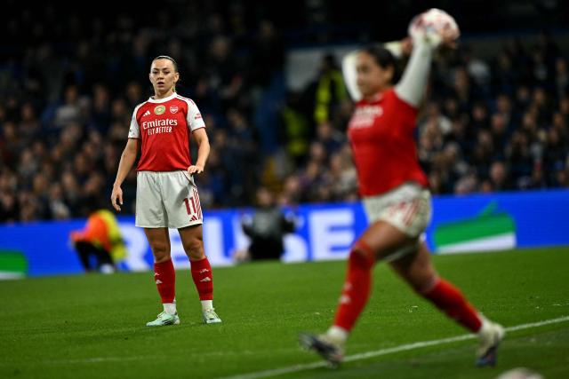 Arsenal's Irish striker #11 Katie McCabe watches Arsenal's Canadian midfielder #15 Olivia Smith taking a throw in during the UEFA Women's Champions League Quarter Final second-leg football match between Chelsea and Arsenal at Stamford Bridge in London on April 1, 2026. (Photo by Ben STANSALL / AFP)