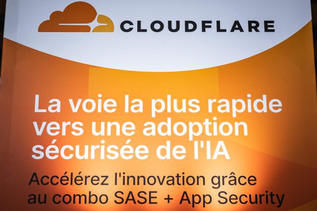 This photograph shows a poser of Cloud Flare AI-Powered technology during the 18th edition of the "InCyber" Forum, an international cyber security event, at the Grand Palais in Lille, northern France on April 1, 2026. The forum, which brings together the entire cybersecurity and “trusted digital” ecosystem, runs until April 2, 2026. (Photo by Sameer Al-DOUMY / AFP)