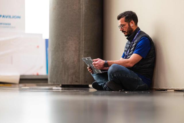 A visitor works on his laptop as he takes part in the 18th edition of the "InCyber" Forum, an international cyber security event, at the Grand Palais in Lille, northern France on April 1, 2026. The forum, which brings together the entire cybersecurity and “trusted digital” ecosystem, runs until April 2, 2026. (Photo by Sameer Al-DOUMY / AFP)
